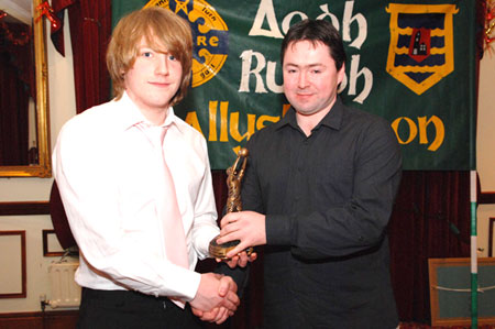 Barry Leonard recieves the Young Footballerof the year from John Hughes.