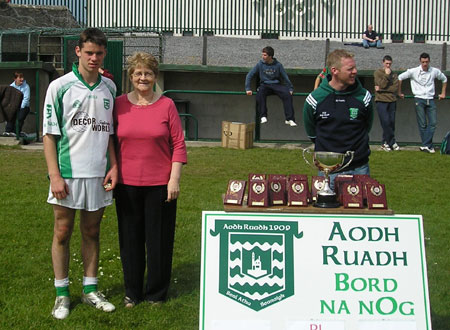 Mary Roper with the Aodh Ruadh captain, David Dolan, after the final of the PJ Roper under 16 tournament in Ballyshannon last Saturday. Brian Roper is to the right of the picture.