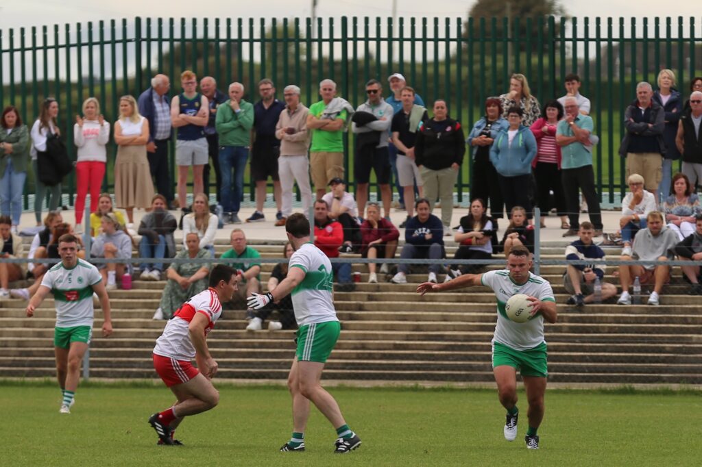 David Dolan prepares to let fly as an expectant terrace watch on.